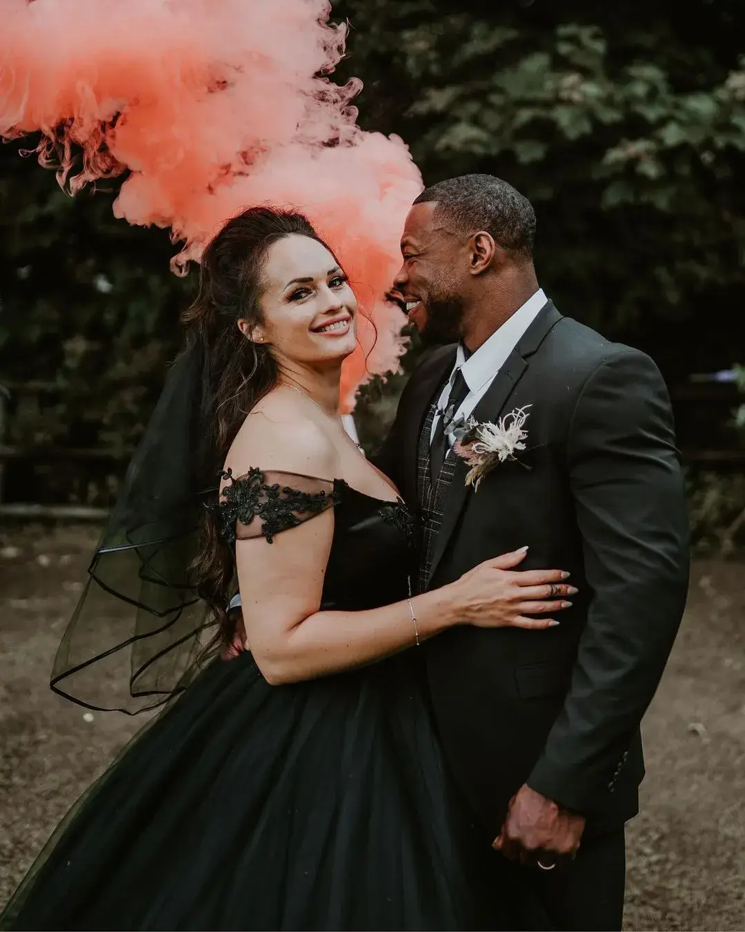 couple posing for wedding photos wearing black