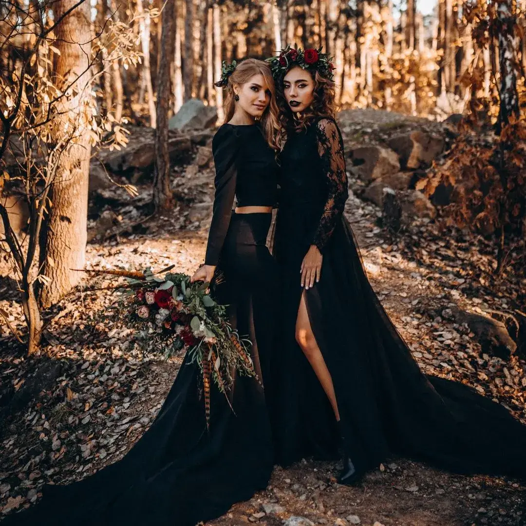 bride and bride at wedding ceremony both wearing black wedding dresses