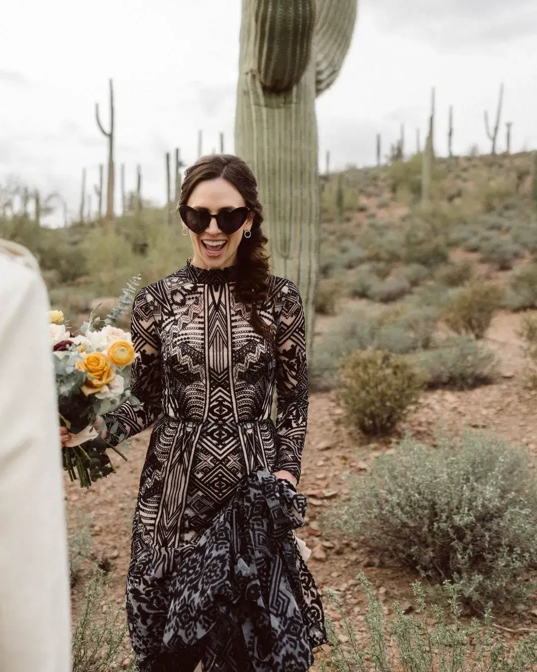 bride in black lace wedding dress with heart sun glasses