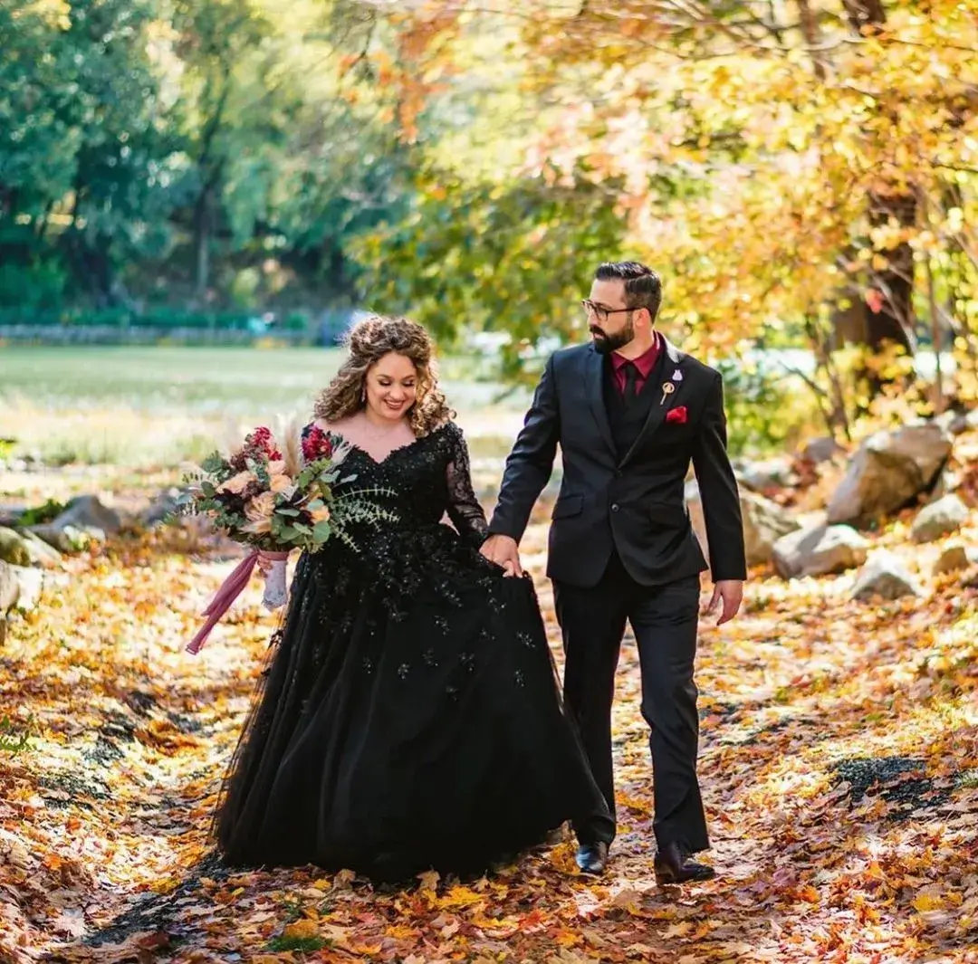 couple togther in the woods both wearing black