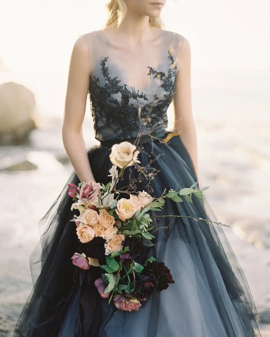 bride in black dress with modern bridal bouquet 