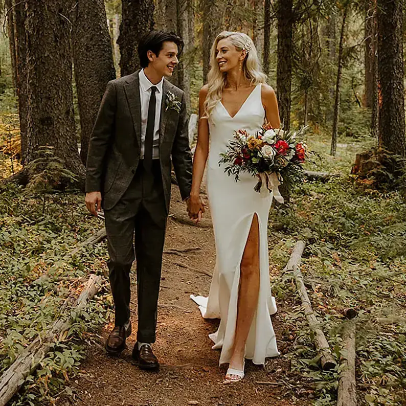 bride and groom posing in woods, brde in cepe dress