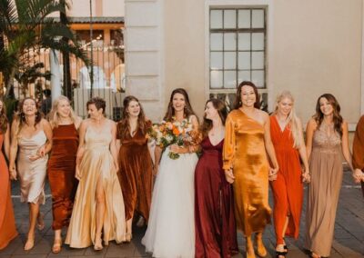 mismatched burnt orange and yellow bridesmaid dresses