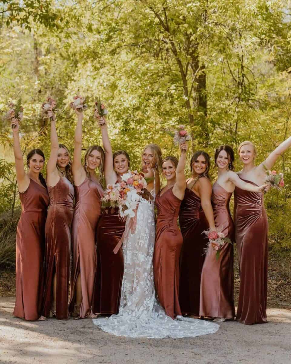 bride with bridesmaids in velvet pink and red bridesmaid dresses