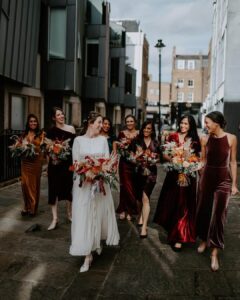 bridesmaid walking down city street with bride