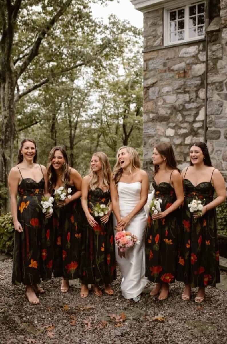 bride with bridesmaids in red floral bridesmaid dresses 