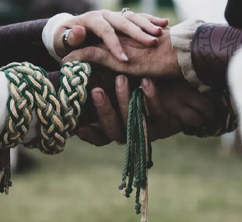 handfasting ceremony - hand being tied as handfasting vows said
