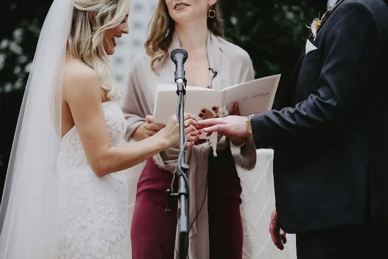 celebrant and couple performing a handfasting ceremony 