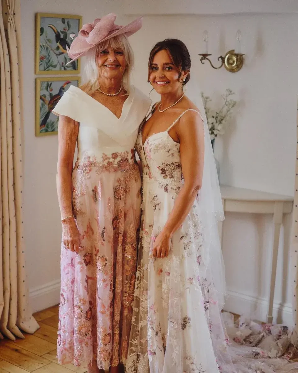 bride in floral dress with her mother on wedding day