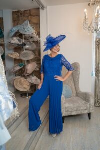 mother of the bride in blue trouser suit and matching blue hat
