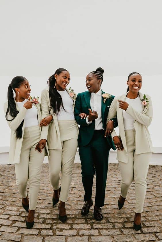 bride and bridesmaid in green suits 