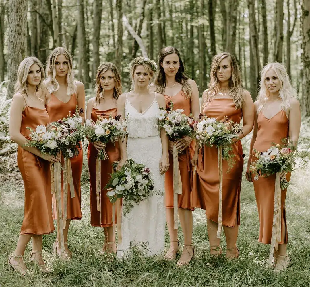 bridesmaid in copper dresses with green rustic bouquets and soft accessories 