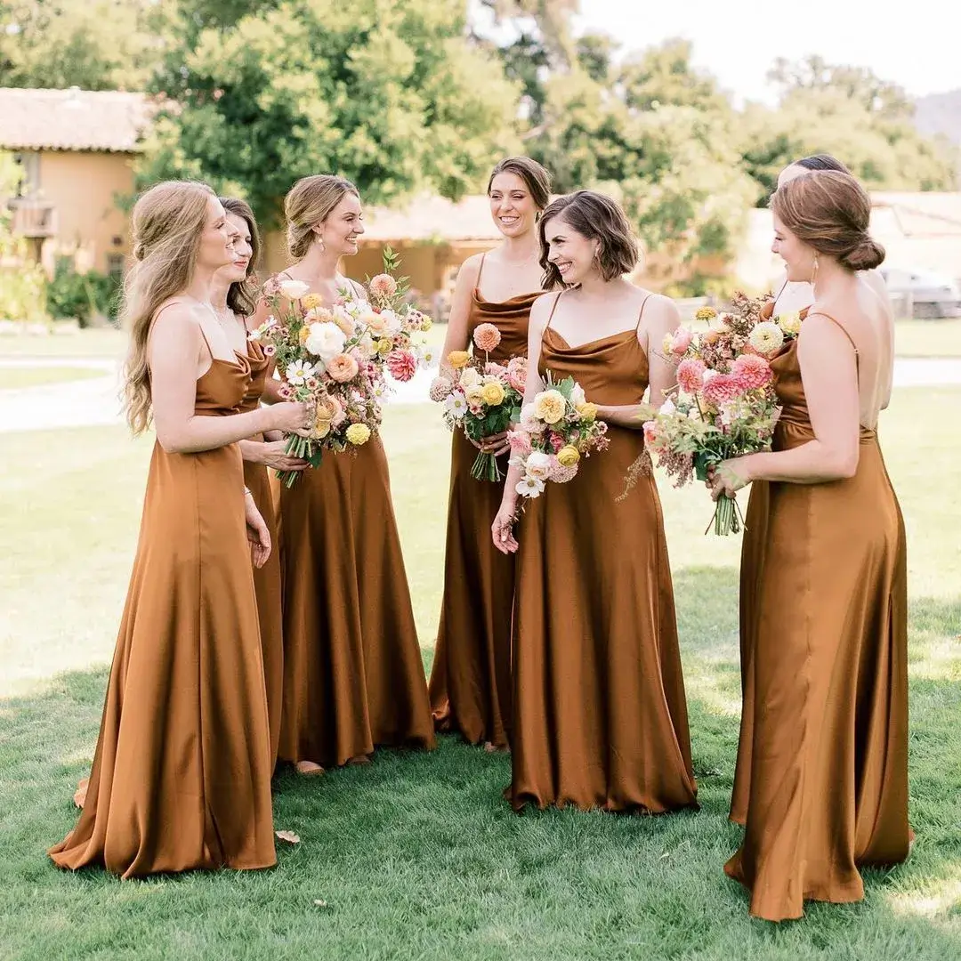 bridesmaid in copper dresses a modern soft colourful bouquets