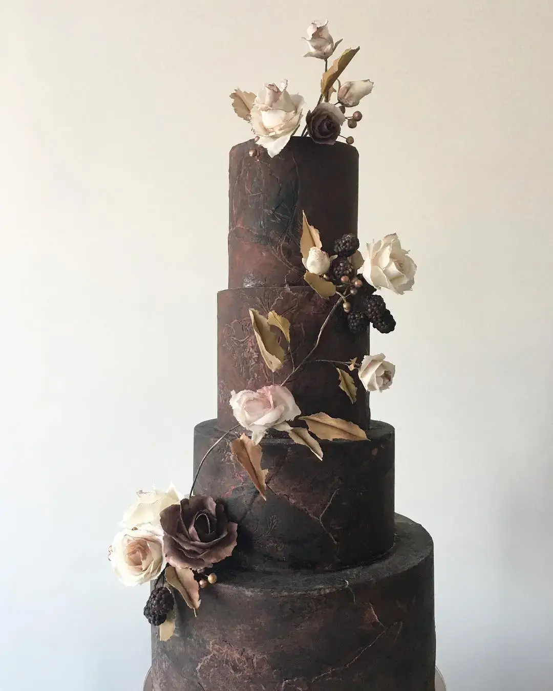 black cake with gold florals
