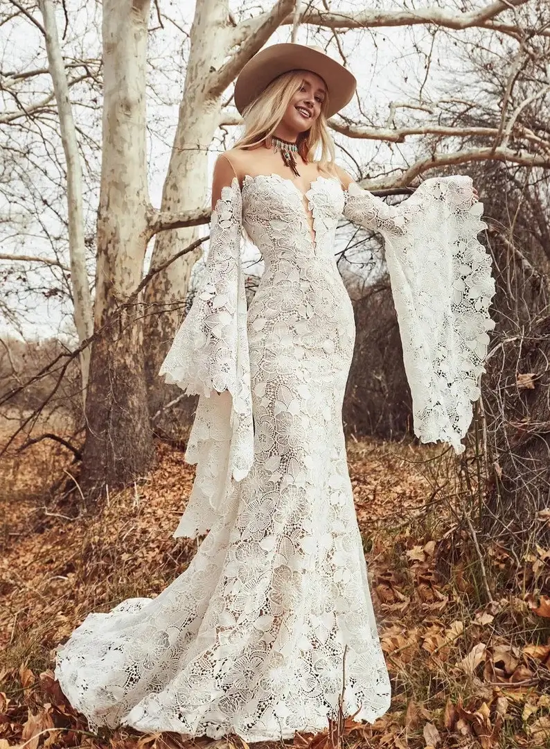 white lace bridal dress with long draping sleeves