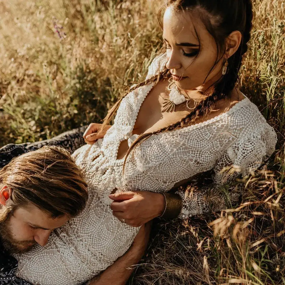  bride in pagan dress with groom lay on grass