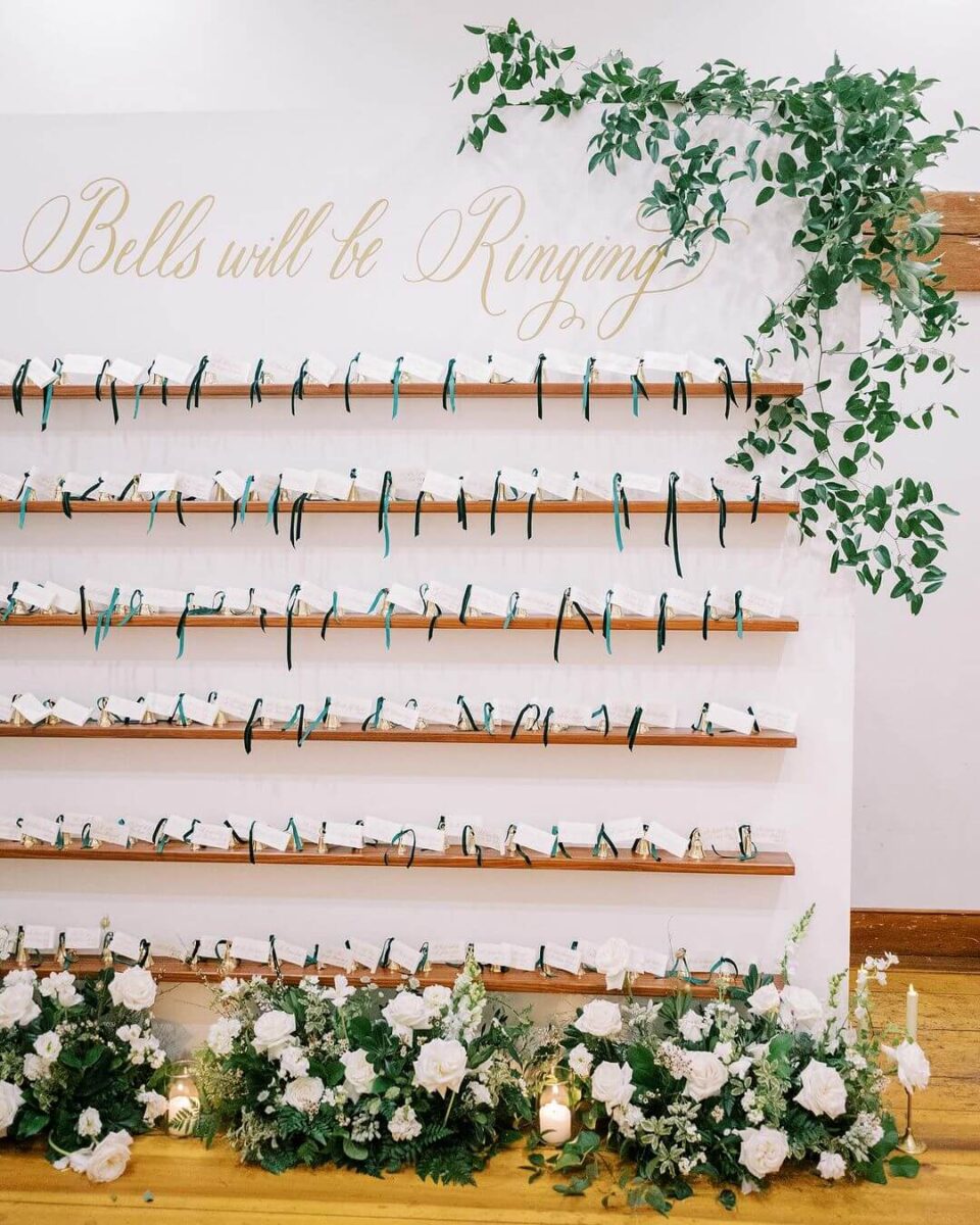 a shelf display at a wedding full of bells for guests 