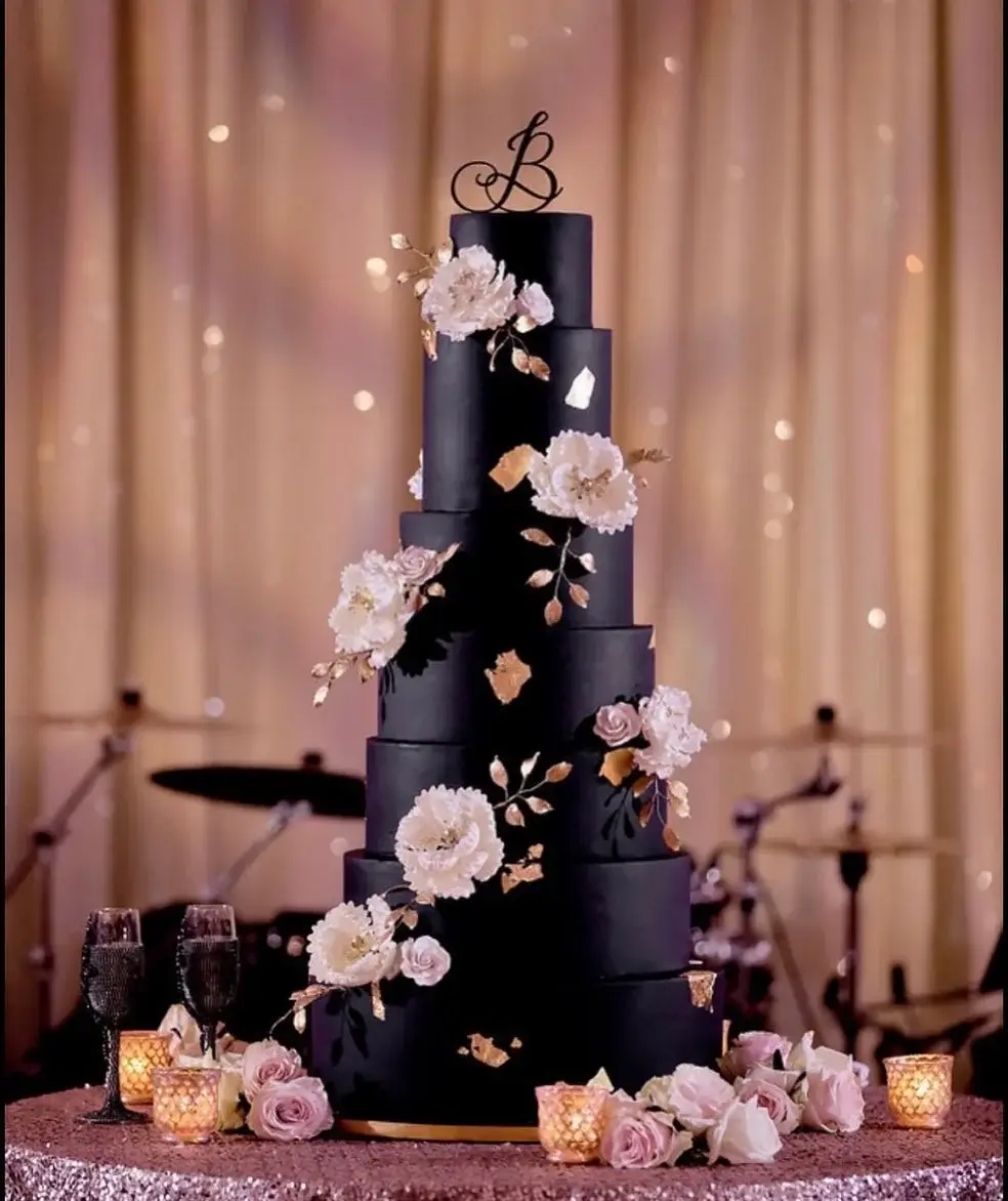 black and gold cake with soft gold flowers
