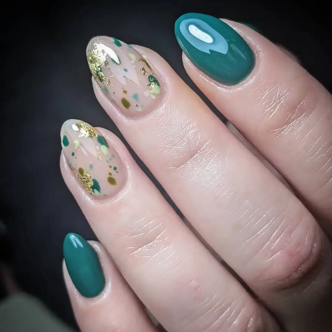 teal blue nails and clear speckled gold nails 