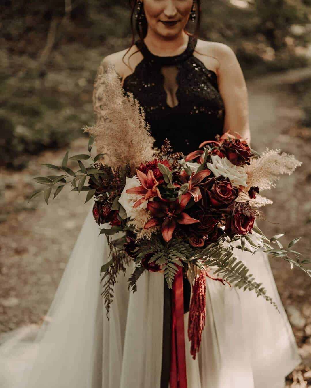 bride holding a moody bouquet 
