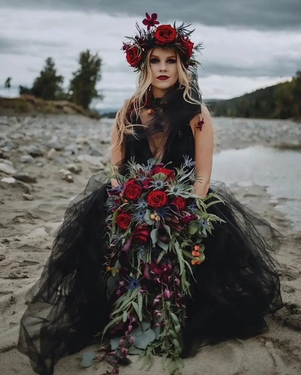bride in black dress holding gothic bouquet 
