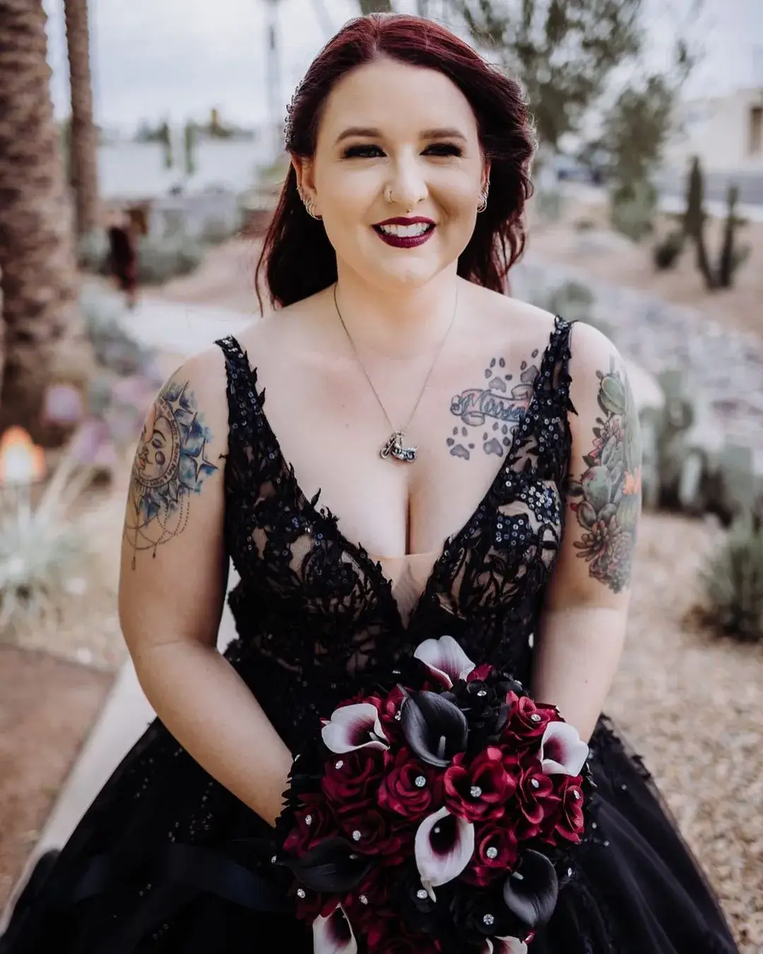 gothic bride holding a bouquet and bold red lipstick