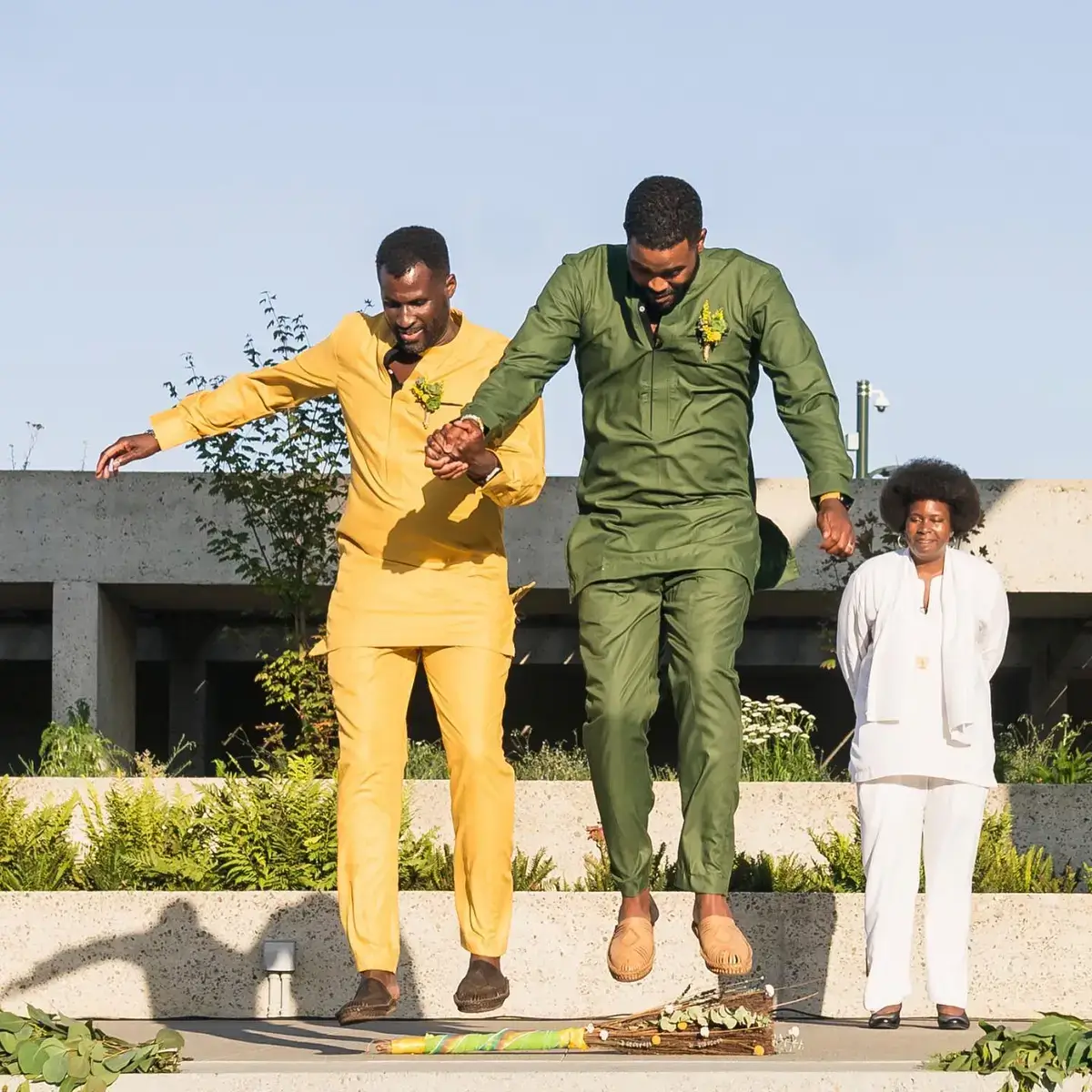 gay couple jumping the broom 