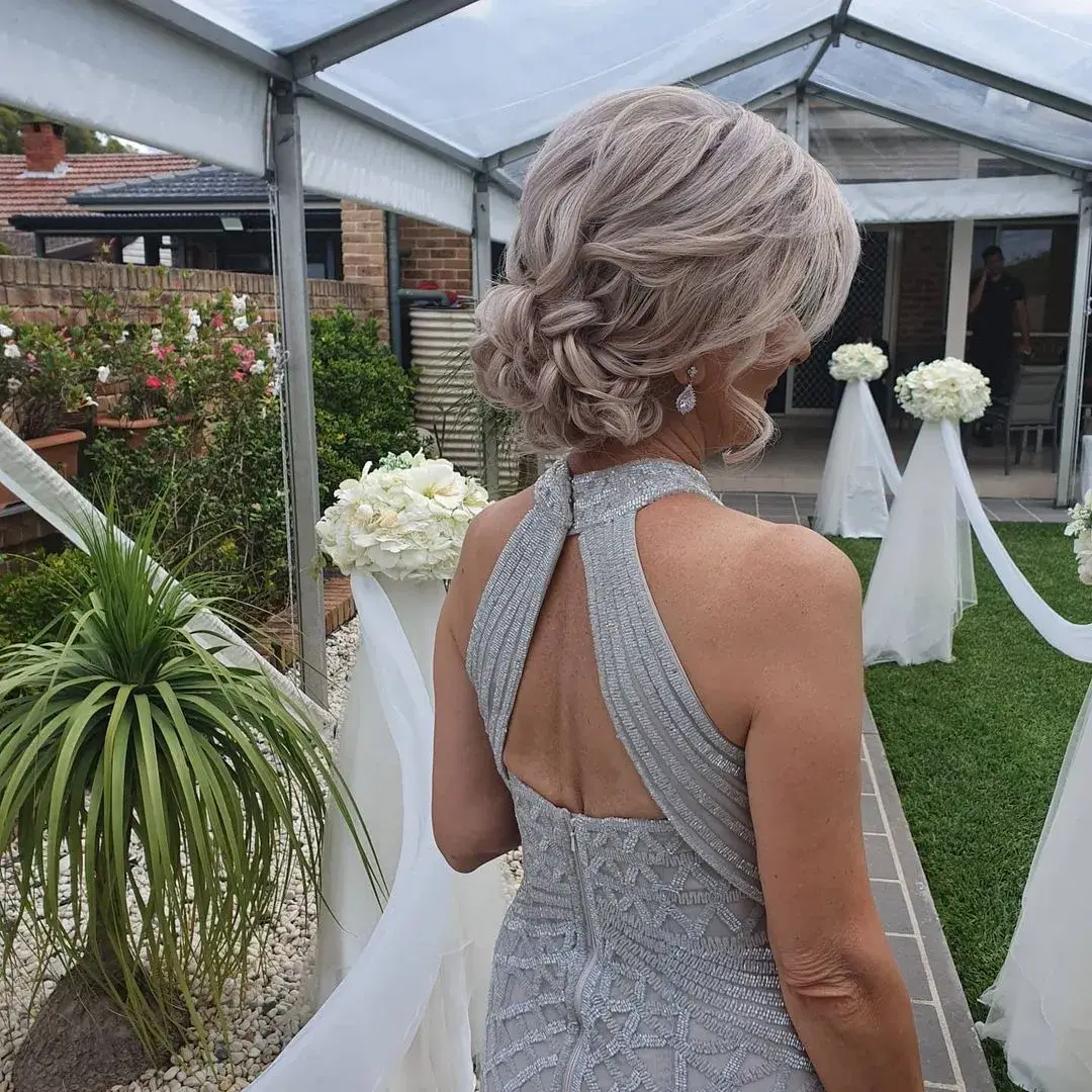 back view of mother of the bride with her short hair pinned lossy on the back