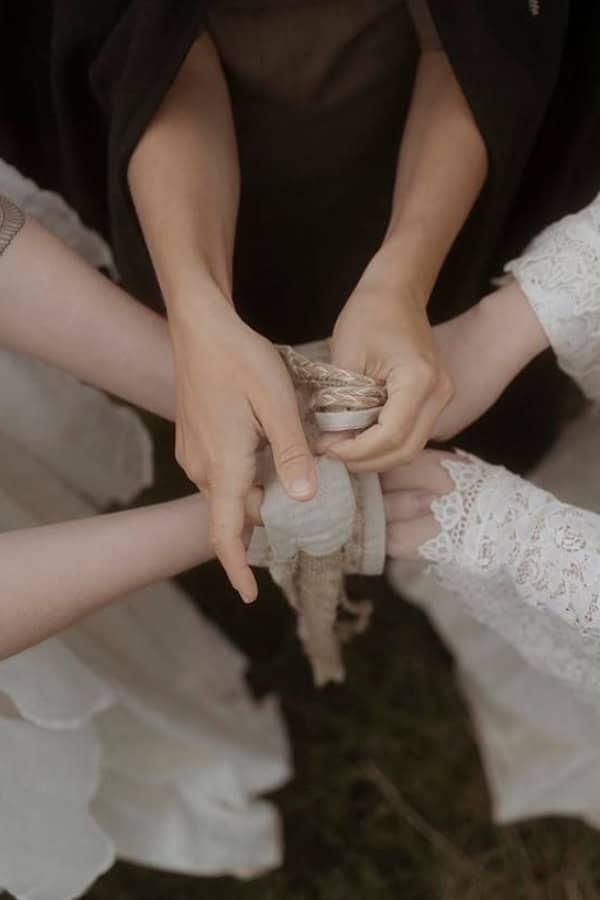 close up of hands being tied at tying the knot pagan ceremony