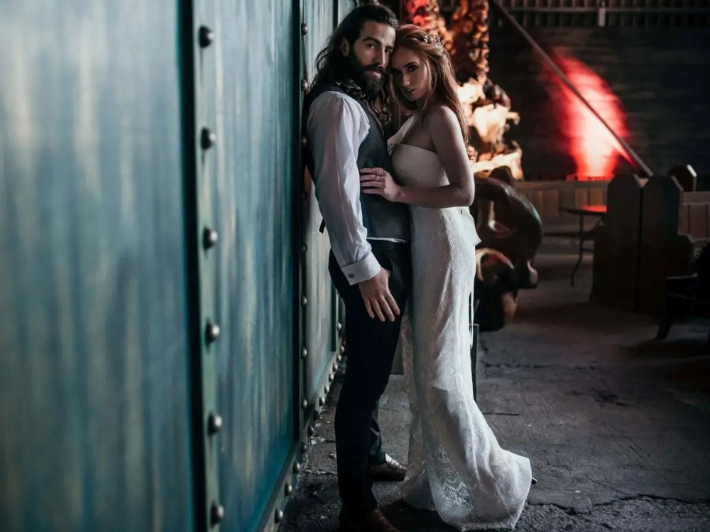 couple embracing outside warehouse wedding venue