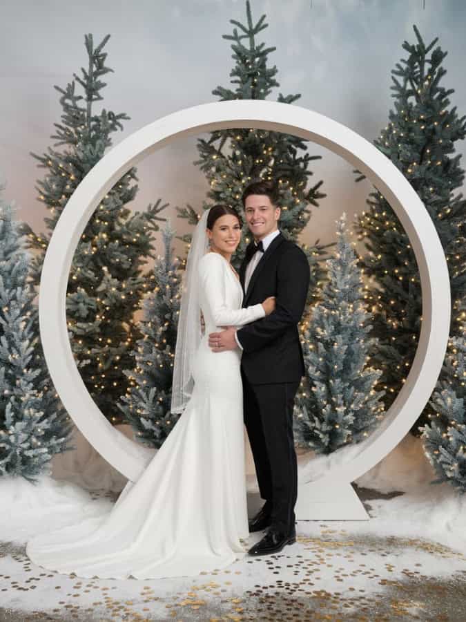 wedding couple in front of snow globe photo booth