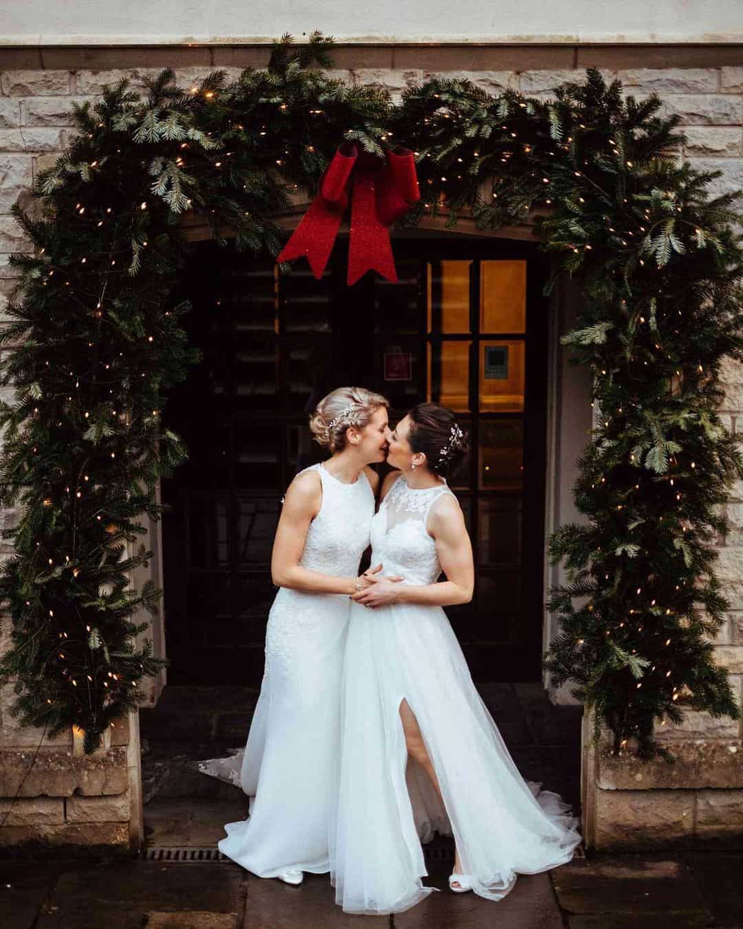 couple outside wedding venue with holiday decor