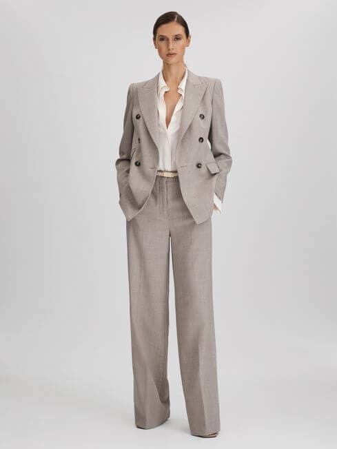 mother in neutral trouser suit, wide leg pants and white shirt