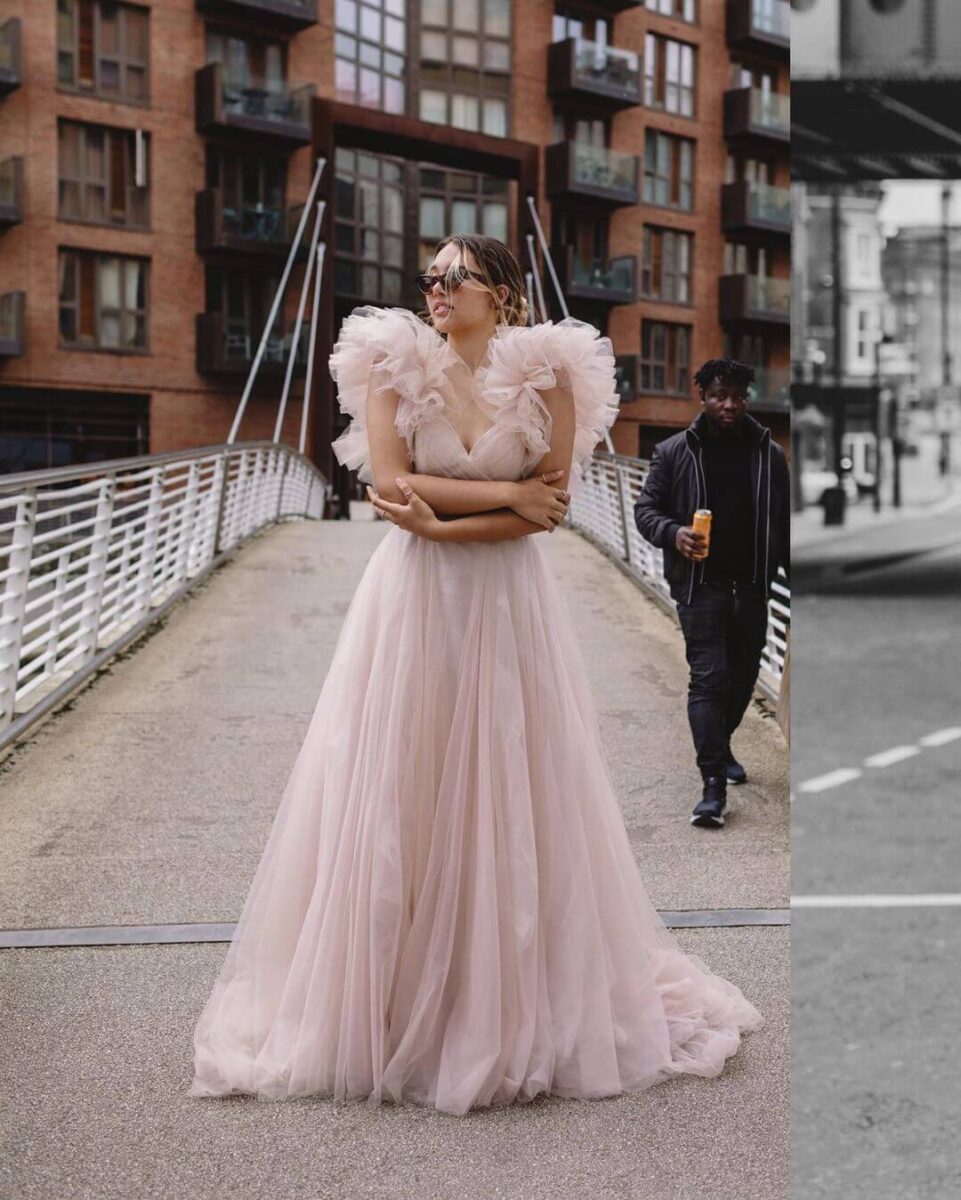 bride in city street with blush pink dress with puff sleeve with sunglasses and hair back 