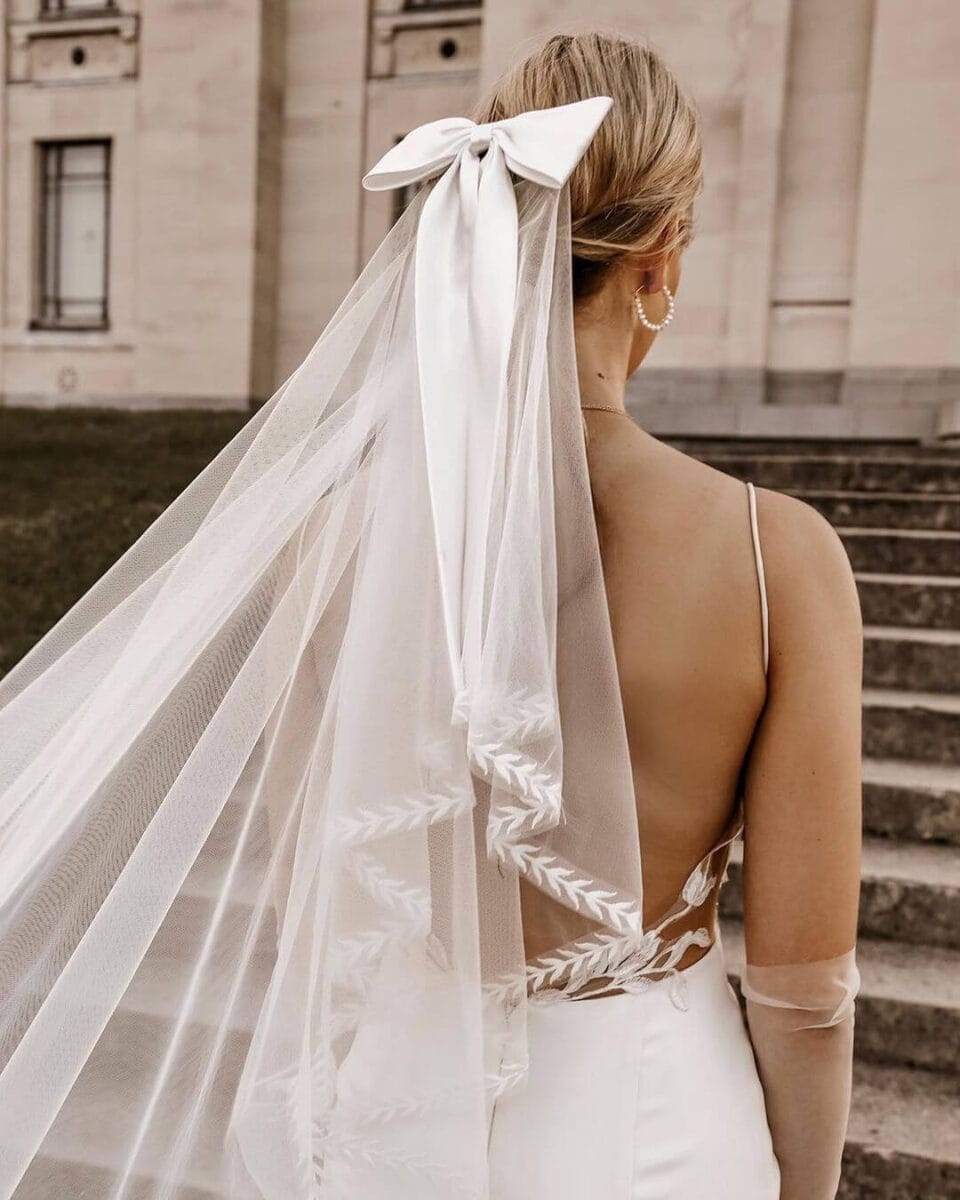 bride in long veil with bow at top 