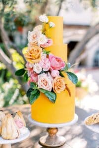 bright yellow summer wedding cake with bold florals