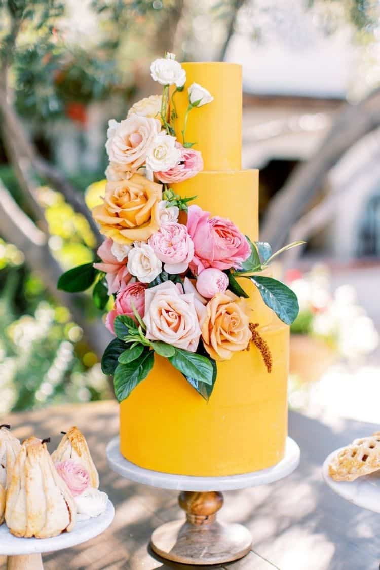 bright yellow summer wedding cake with bold florals