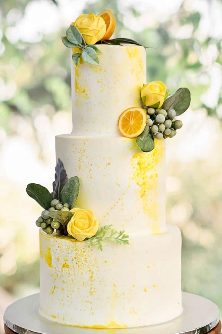 simple wedding cake with lemons and yellow flowers