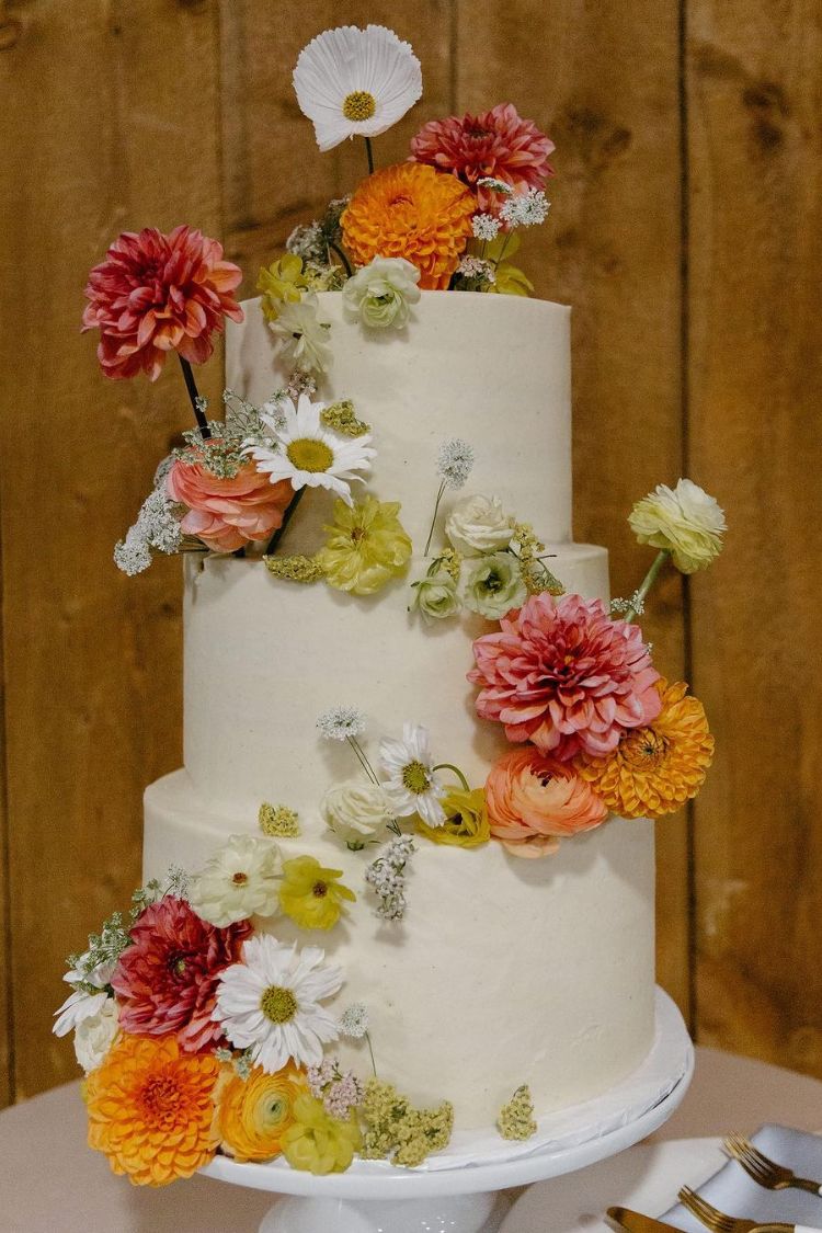 white cake with bright and bold summer flowers