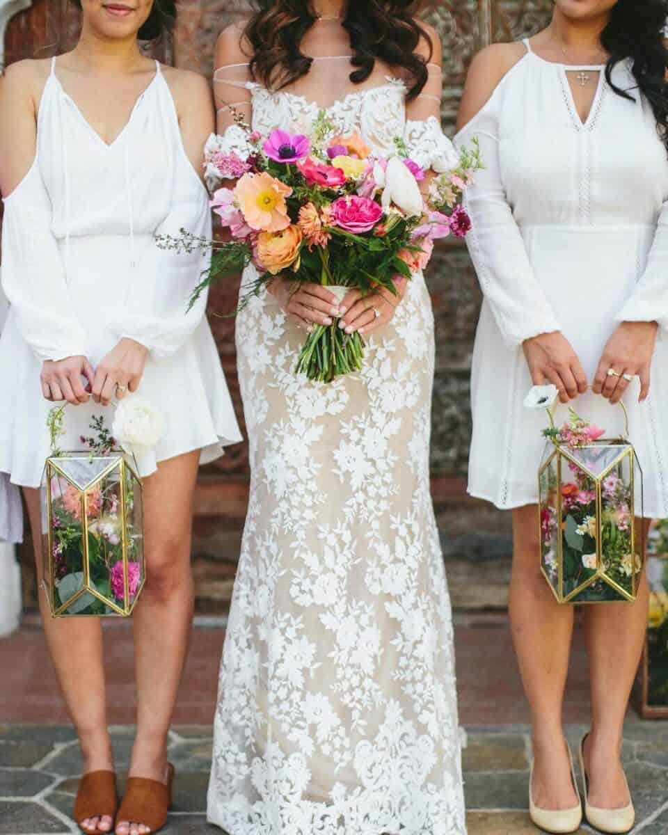 bride with colorful bouquet and bridesmaids with gold lanterns and colorful flowers 