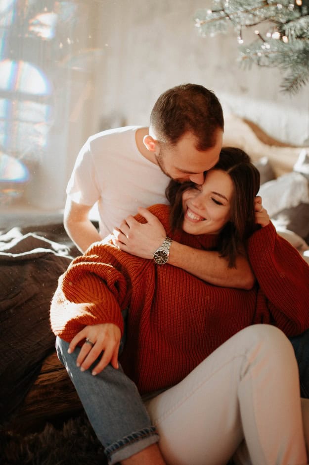 couple embracing on the sofa at christmas