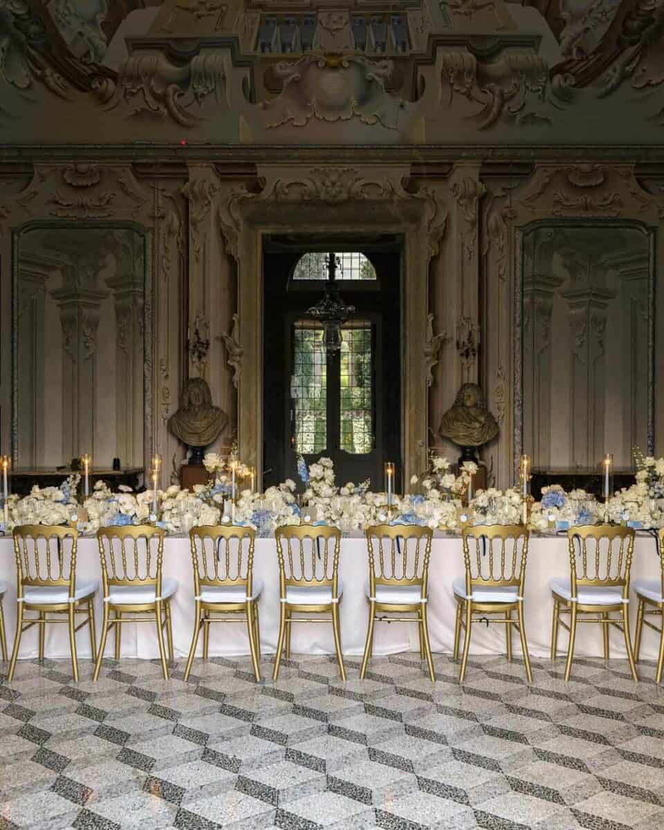 table set up in a manor venue with regal old money vibes