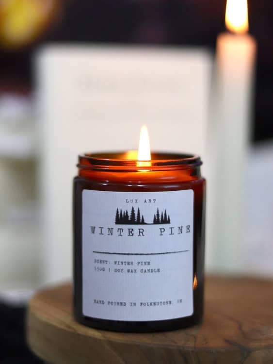 dark jar lit candle with a minimal label with personalised wedding details 