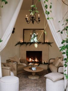 a wedding lounge with comfy chairs and fireplace to keep guest warm