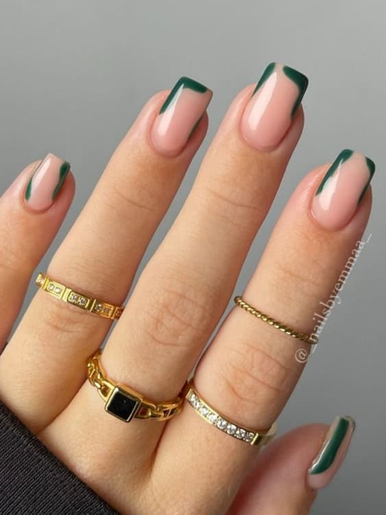 square-shaped nails feature a nude base with dark green, wavy French tips