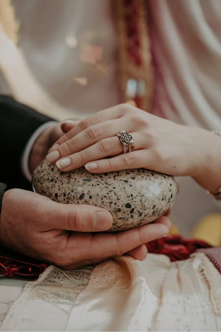 couple holding and oathing stone at their ceremony