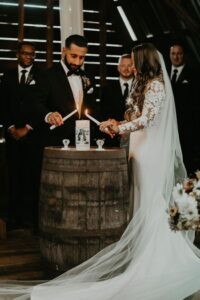 unity wedding ceremony with couple lighting candle