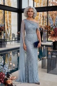 Beautiful silver mother of the bride dress with sequins and cape detail.